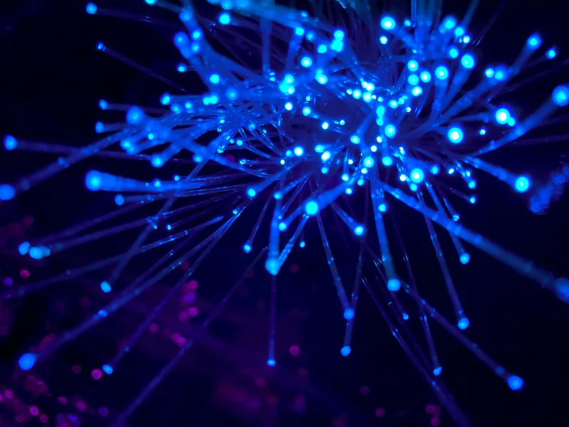 Fiber optic cables glowing with blue and purple light